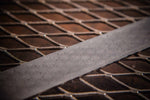 A stainless steel damascus billet in raindrop pattern made by vegas forge