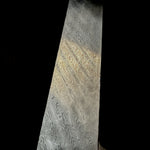 close-up of Tilted Ladder San Mai featuring an AEB-L core with AEB-L and 304 stainless Damascus outer layers. The 45-degree ladder pattern creates bold movement and striking contrast.