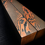 two block of vegas forge copper infused damascus in twist pattern on black background