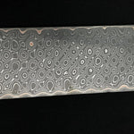picture of a python patterned carbon core san mai damascus billet with copper layers