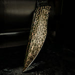 Close-up of Copperhead San Mai fixed blade showing copper-infused Damascus pattern