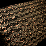 close up image of the copperhead pattern san mai with flowing silver lines and dark black circles on background