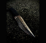 very cool fixed blade made with copperhead san mai, sitting on black textured floor