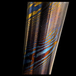 a twisted damtanium round bar made with layers of grade 2 titanium and grade 5 titanium, also known as titanium damascus, mokuti of timascus