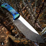 Custom hunting knife with blue handle and Vegas Forge Fireball stainless Damascus blade, highlighting fiery pattern.