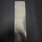 fireball pattern damascus billet sitting on black table