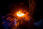 Hammering a 2200 degree block of stainless damascus steel