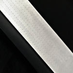 a block of vegas forge stainless damascus herringbone pattern on a black background