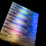 a billet of Ladder pattern zirmascus also known as black ti or zircuti featuring bright blue, grey and yellow colors that are flamed into the billet