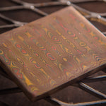 close up picture of a mokume gane billet in ladder pattern