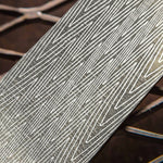 close up picture of a lightning patterned damascus steel billet