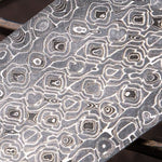 Lytic Damascus billet close-up showing fluid wave pattern