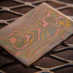 a random pattern mokume gane billet made with layers of copper, brass and nickel-silver