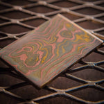 a random pattern mokume gane billet made with layers of copper, brass and nickel-silver