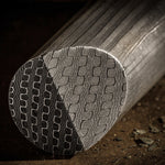 Close-up of Reptilian Damascus round bar showing bold etched scale-like pattern