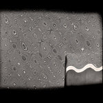 close up image of the riptide pattern san mai with bevel ground into flat bar revealing the core material