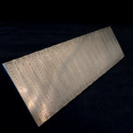 full knife blank billet of sharktooth pattern damascus steel billet on a black background