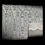 close up picture of a stainless snakeskin patterned san mai billet from vegas forge