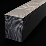 close up vegas forge spirograph pattern damascus steel block on a dark black background