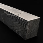close up on stainless spirograph pattern damascus block on a black background