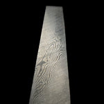 Decorative damascus billet with intricate patterns on a black background