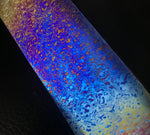 Colorful marbled pattern on a black background