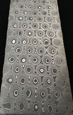 billet of typhoon patterned copper infused carbon san mai damascus that was made by vegas forge