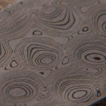 close up picture of a typhoon patterned damascus billet made by the best damascus smiths vegas forge