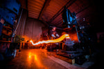 a blacksmith from vegas forge hammering a canister of damascus steel