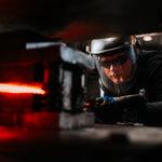 a blacksmith at vegas forge pressing pattern into a stianless damascus billet