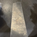 Decorative stone with engraved patterns on a concrete floor