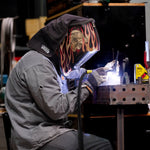 welder tig welding a stainless damascus canister at welding station